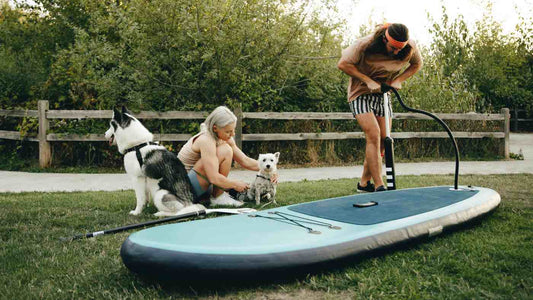 Person pumping up Paddle Board with hand pump