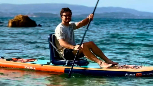 Person sitting on Paddle Board with seat attachment