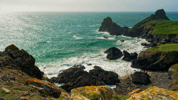 UK beach with steep, rocky surroundings and a windy ocean